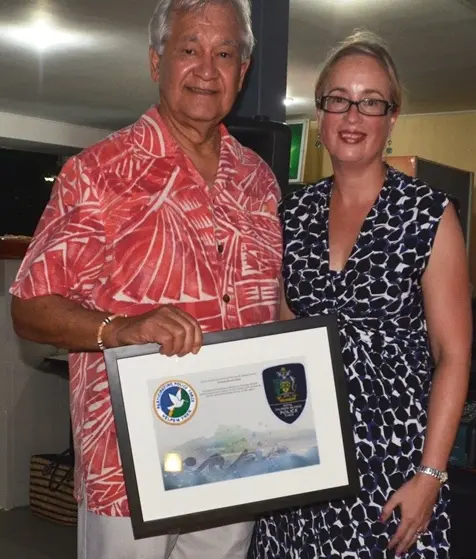 Secretary General of the Pacific Islands Forum, Tuiloma Neroni Slade receives a farewell gift from RAMSI Special Coordinator, Ms Justine Braithwaite during a RAMSI hosted function in Honiara.
