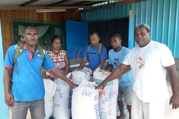 Mr. Warren Mane (L) with his Kava ready to be sold.