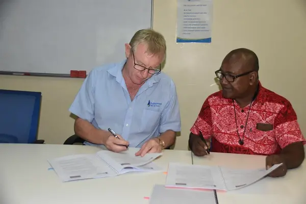 The Solomon Water CEO, Mr. Ian Gooden (L) and Solomon Post CEO, Mr. Alfred Ghemu (R) signining the Ezipei service contract.