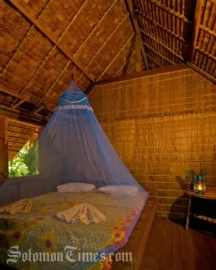 A room in a traditional leaf house at the TDA-run Tetepare Island Ecolodge.