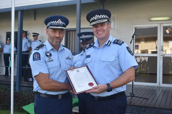 RSIPF Commissioner Varley presents outgoing SIPSP Team Leader Razos with a letter of commendation.