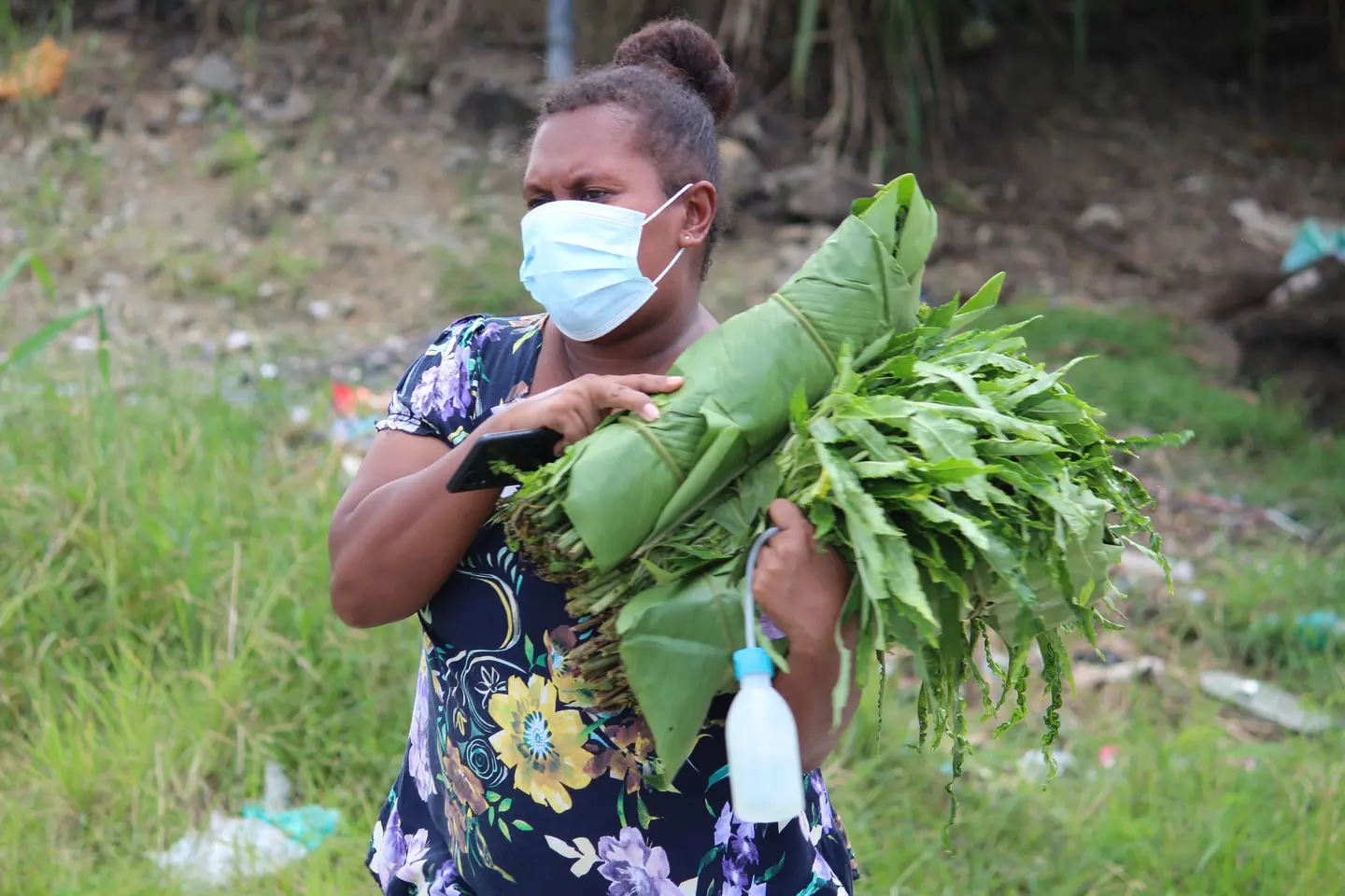 A mother purchases fresh vegetables from the mobile market team.