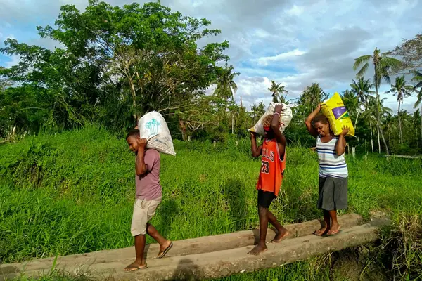 "Women and children have to cross rivers and walk long distances with heavy loads of bags”, Chief Titus Teddy says.