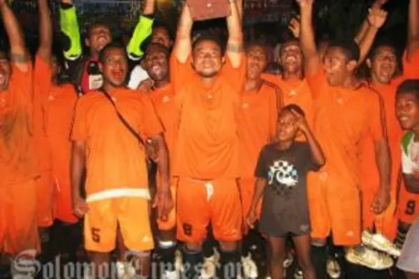 Lesley Ngiumona, captain of Sipa FC, lifting the winner's trophy.