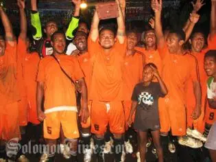 Lesley Ngiumona, captain of Sipa FC, lifting the winner's trophy.
