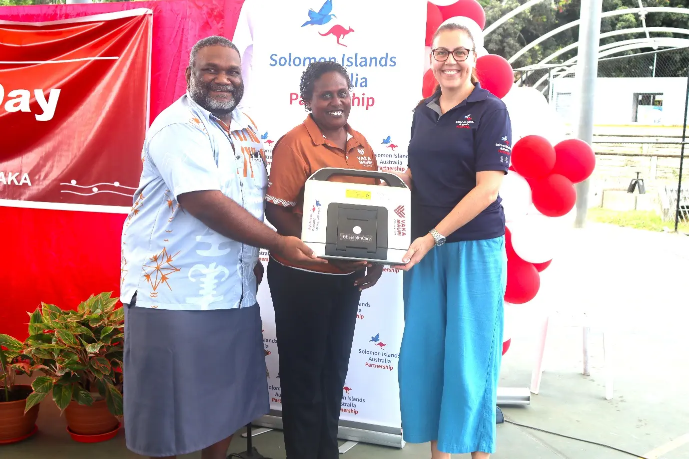 Ms Erin Ferguson, Senior Program Manager for the Health Team at DFAT, hands over the echocardiography machine to Deputy Secretary Health Improvement Dr Nemia Bainivalu and a representative of people living with rheumatic heart disease.