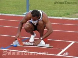 Fiji's Jone Wainiqolo sets his starting block before running the Men's 400m hurdles for which he took the gold medal at 55.12 seconds.