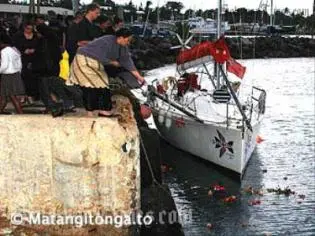 Flowers are thrown over the last mooring place of the MV Princess Ashika.