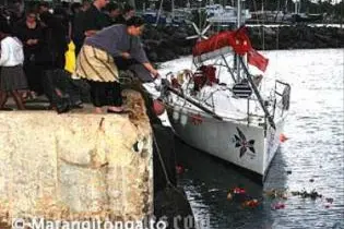 Flowers are thrown over the last mooring place of the MV Princess Ashika.