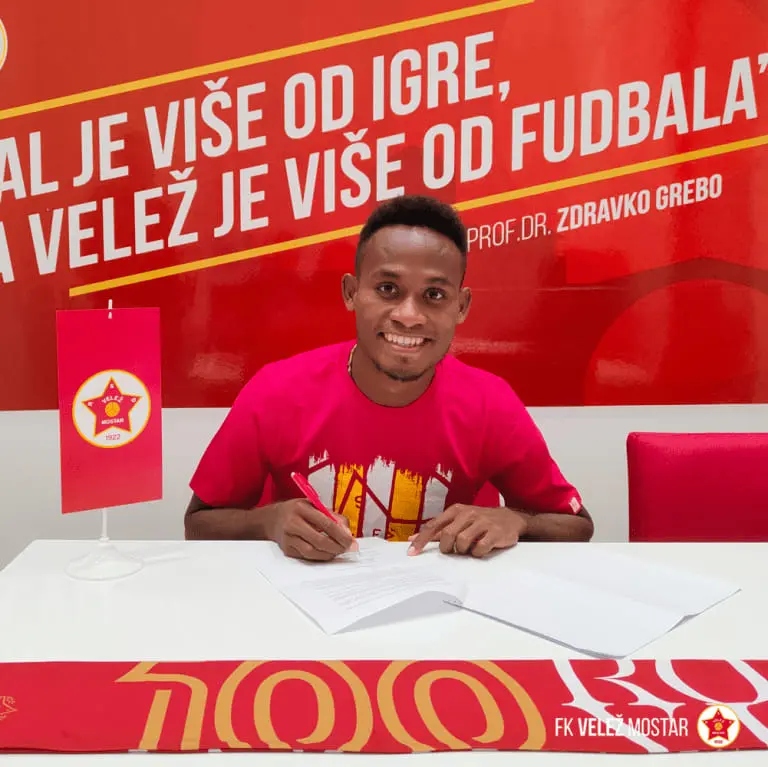 Lea'i puts pen to paper, inking his first professional football contract - and the country's first in Europe.