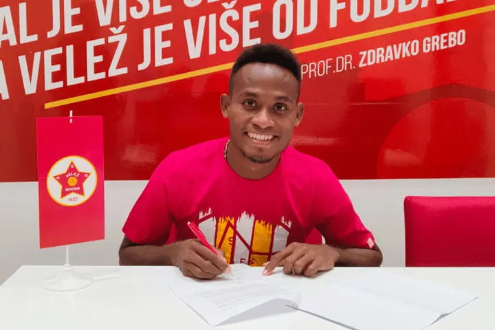 Lea'i puts pen to paper, inking his first professional football contract - and the country's first in Europe.