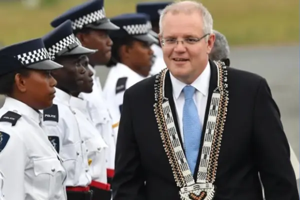 Australian Prime Minister Scott Morrison inspects a guard of honour by the Royal Solomon Islands Police Force after arriving at Honiara International Airport yesterday.