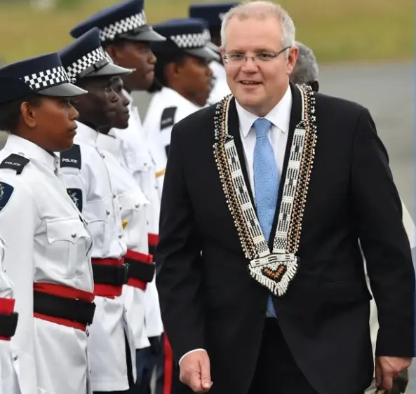 Australian Prime Minister Scott Morrison inspects a guard of honour by the Royal Solomon Islands Police Force after arriving at Honiara International Airport yesterday.