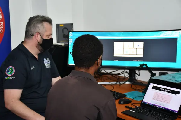 RSIPF member and AFP Advisor reviewing the new digital forensic capability.