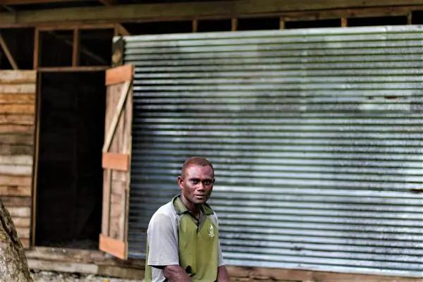 Charles Wesley Daveta from Lale village, Ranongga Island, in the Western Province, sits in front of his cocoa shed.