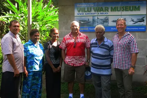 The Fijian Prime Minister stands with Glenn Bennett, Managing Director, Silentworld Shipping (far right), Reginald Douglas, director of Dalgro (far left) as well as museum owners Anderson Dua and his family.