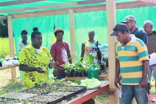 Clement Totu, field officer Guadalcanal agriculture extension office explains to farmers the processes of Noni propagation at the Propagation/Nursery booth during the Noni field day at T.W. Enterprise Noni farm at LDA area. 