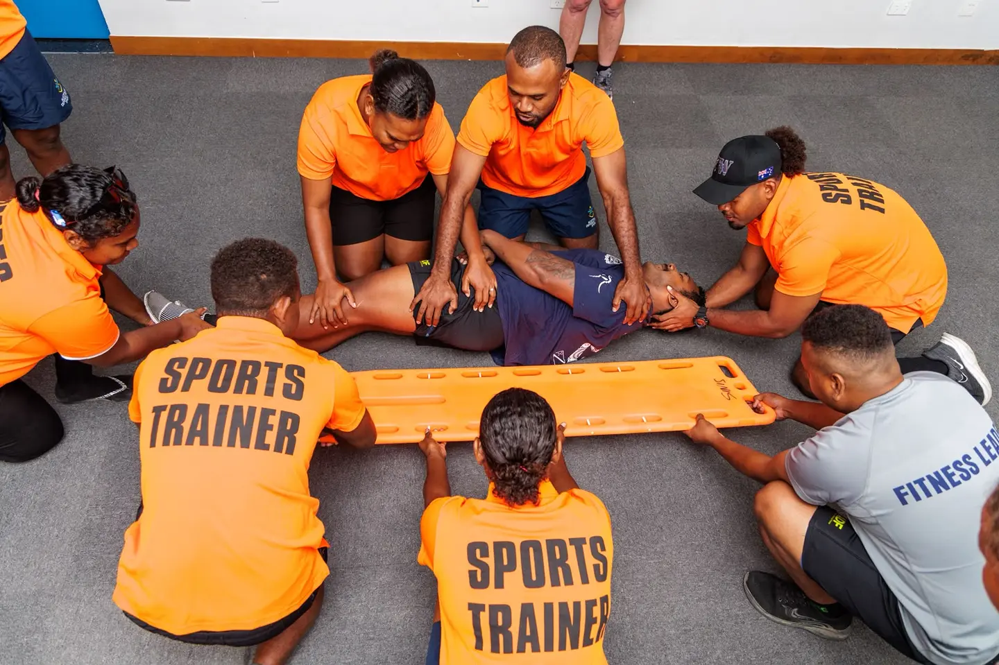 Solomon Islanders practise spinal injury first aid during the sports trainer course.