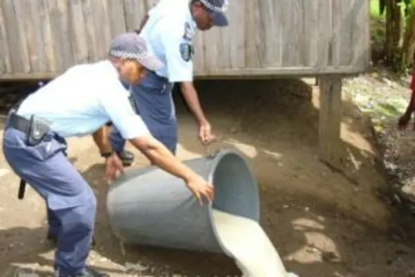 Police officers during one of many raids in attempts to stop illegal brewing of kwaso.