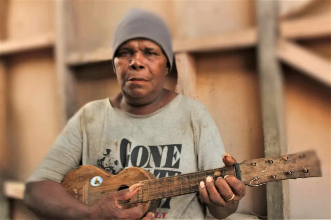 Jackson Akwasia with his homemade ukulele.