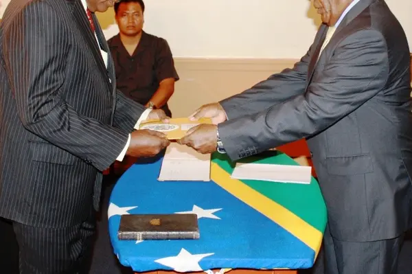 Mr Ngele receives his credentials from Sir Frank on Friday.