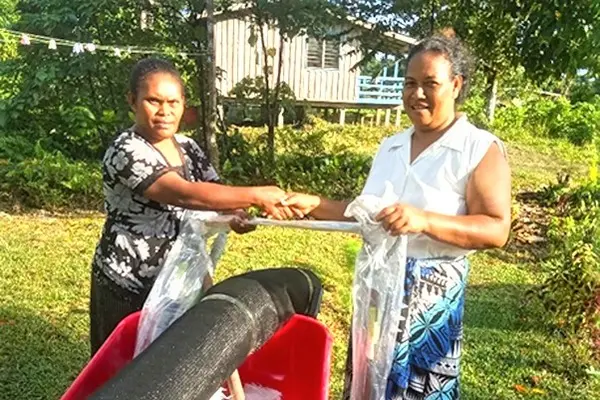 MAL Extension officer in Renbel, Florence Kwai hands over kava project farming tools to the representative of Renkav new kava planting family project.
