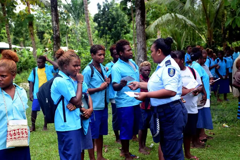 Local RSIPF officer shares the NGE pamphlets with students who attended one of the awareness programs.