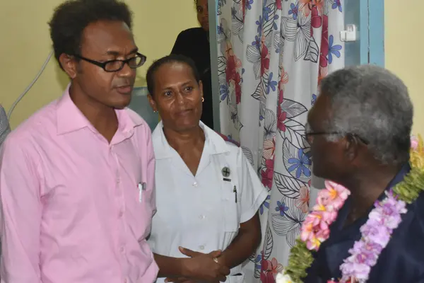 Dr Jack Siwainao talking with the Prime Minister during his visit.