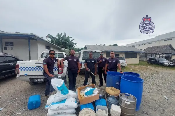 Police with the confiscated kwaso items used for the production of the illegal homebrew. 