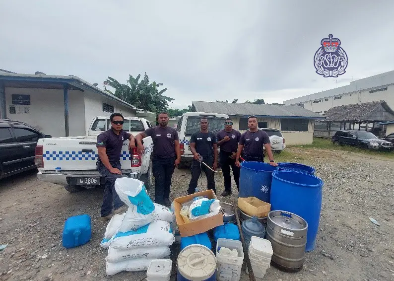 Police with the confiscated kwaso items used for the production of the illegal homebrew.