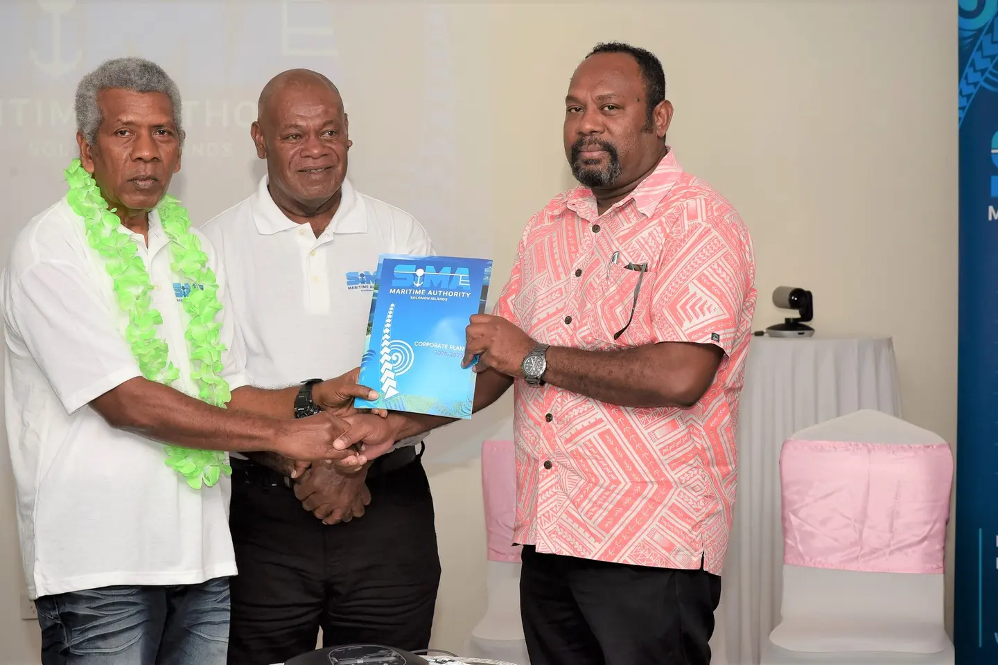 (L-R) Chairman of the SIMA board, Robert Bokelema, a staff from SIMA and MID Deputy Secretary, Jimmy Nuake with the newly launched corporate plan document
