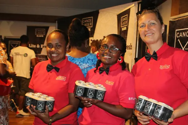 SolBrew staff (l-r) Serah Baulo, Brew Manager, Naomi Kalamani, QC Manager and Polona Berlec, Logistics Manager with Canoe Black 6 packs for guests.