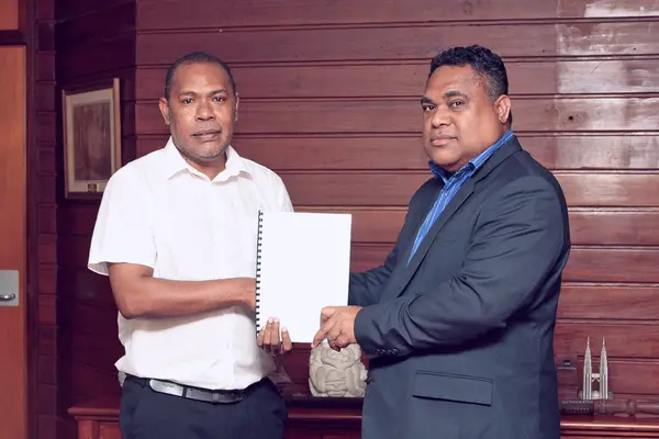 Smiley Giobauta, IFC's country officer for Solomon Islands and Dr Luke Forau, Central Bank Governor, after the signing.