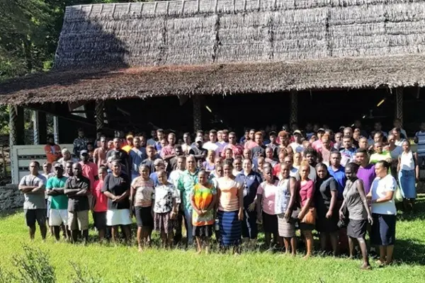 MFAET PS Mr Collin Beck and Second Secretary Christina Skoumbourdis from the Australian High Commission in a photo shoot together with the workers after the Pre-departure briefing at St. Barnabas Leaf hut.