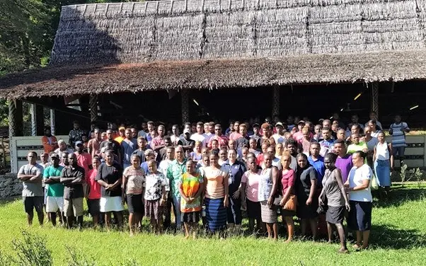 MFAET PS Mr Collin Beck and Second Secretary Christina Skoumbourdis from the Australian High Commission in a photo shoot together with the workers after the Pre-departure briefing at St. Barnabas Leaf hut.