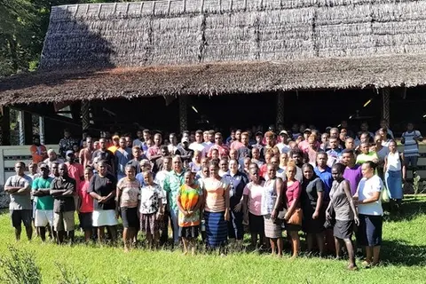 MFAET PS Mr Collin Beck and Second Secretary Christina Skoumbourdis from the Australian High Commission in a photo shoot together with the workers after the Pre-departure briefing at St. Barnabas Leaf hut.