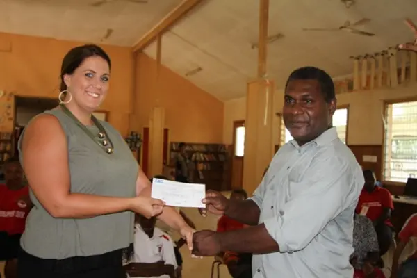 Second Secretary & Consul, Australian High Commission, Natasha Whelan, presents Mr. Jiope, school principal, with a grant for the Livelihood project.