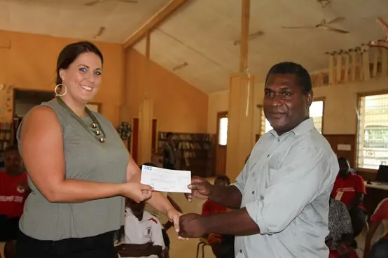 Second Secretary & Consul, Australian High Commission, Natasha Whelan, presents Mr. Jiope, school principal, with a grant for the Livelihood project.