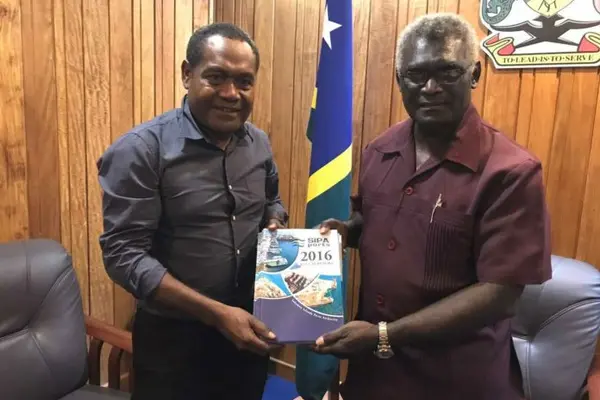 Chairman of SIPA Board, Mr Titiulu, left, handing over the Annual Reports for years 2011 - 2016 to Prime Minister Sogavare.