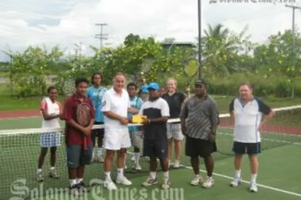 Australian High Commissioner, Frank Ingruber, handing over the cheque to SI Tennis Federation's David Wingston.