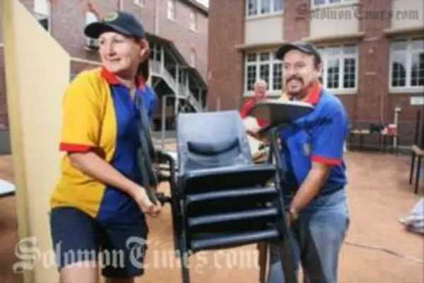 Rotary Club of Booval president Cheryl-Anne DeLima and past president Russell Bentley loading furnitures to be donated to Auki Primary.