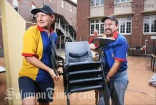 Rotary Club of Booval president Cheryl-Anne DeLima and past president Russell Bentley loading furnitures to be donated to Auki Primary.
