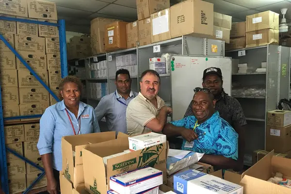 SolBrew handover Medicine to NRH Pharmacy - Dr John Hue, Medical Superintendent and Supervising CEO NRH with Peralt van der Merwe SolBrew MD (centre) looked on by Grace Campbell (far left) and Acting Chief Pharmacist Solomon Bosa (back right).