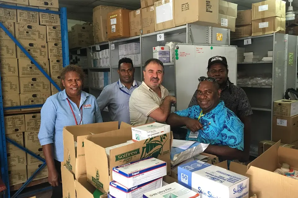 SolBrew handover Medicine to NRH Pharmacy - Dr John Hue, Medical Superintendent and Supervising CEO NRH with Peralt van der Merwe SolBrew MD (centre) looked on by Grace Campbell (far left) and Acting Chief Pharmacist Solomon Bosa (back right).