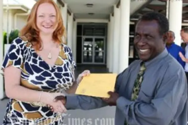 Acting Australian High Commissioner Alison Duncan receives a letter of support from the Minister for Agriculture and Livestock, Hon Connelly Sandakabatu for the PHAMA program.