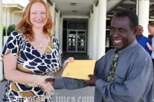 Acting Australian High Commissioner Alison Duncan receives a letter of support from the Minister for Agriculture and Livestock, Hon Connelly Sandakabatu for the PHAMA program.