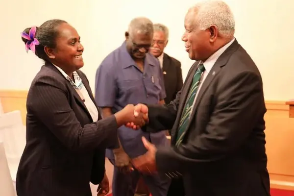 Solomon Islands' new Minister for Women, Youths, Children and Family Affairs, Lanelle Tanangada, shakes hands with prime minister Rick Hou after her swearing in ceremony at Government House in Honiara.