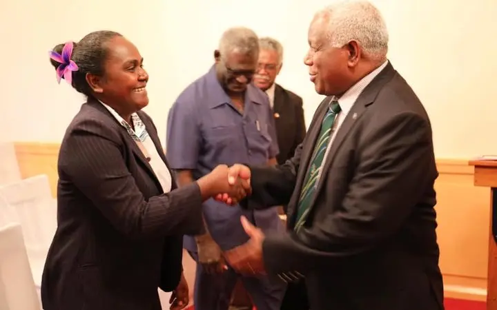 Solomon Islands' new Minister for Women, Youths, Children and Family Affairs, Lanelle Tanangada, shakes hands with prime minister Rick Hou after her swearing in ceremony at Government House in Honiara.
