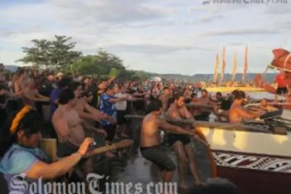 The New Zealand delegation pulls their Vaka ashore as the crowd looks on.