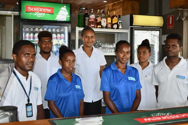 Tina River Hydro CBSP sponsored students, Rita Soloni and Emelda Bineth (in blue shirts) with their colleagues at the SINU-owned Lokol Fusion Café & Bar, where they are currently doing their internship.